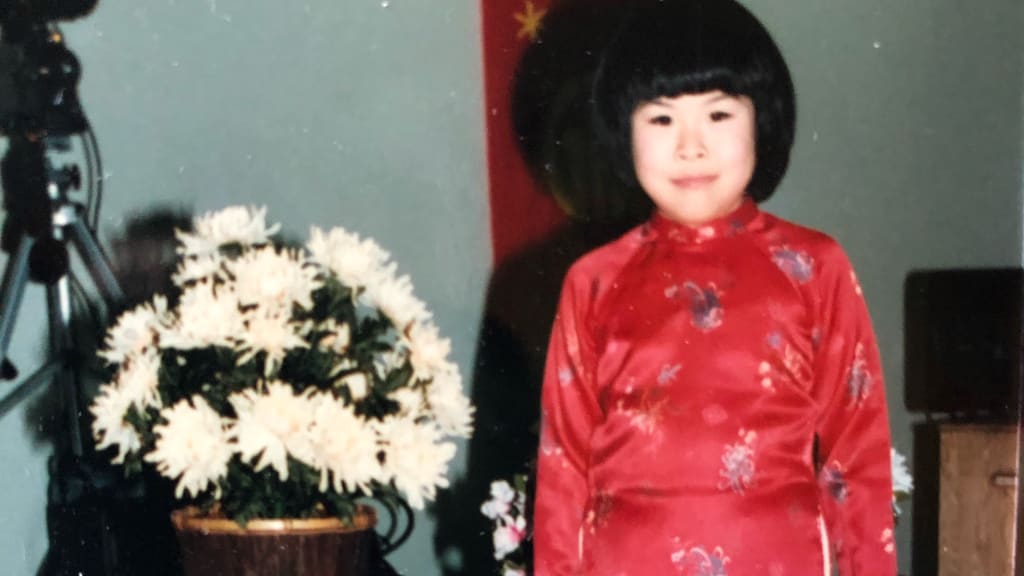 Ngoc Do wearing a traditional Vietnamese dress, áo dài, at a community Tết (Lunar New Year).