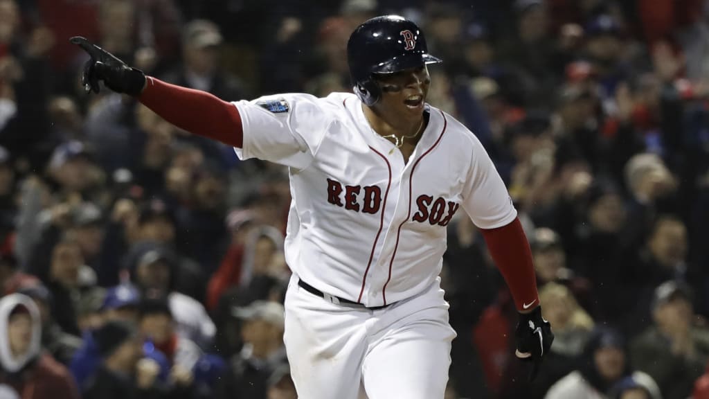 Boston Red Sox's Rafael Devers hits an RBI single to score Andrew Benintendi during the fifth inning of Game 1 of the World Series baseball game Tuesday, Oct. 23, 2018, in Boston. (AP Photo/David J. Phillip)