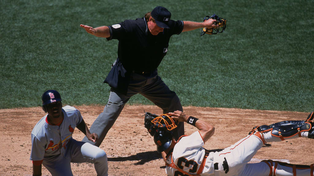 1 Jul 2001: Umpire Jim McKean calls Kerry Robinson #13 of the St. Louis Cardinals who slid into home plate while catcher Benito Santiago #33 tried to tag him while blocking the plate safe during the game against the San Francisco Giants at Pac Bell Park in San Francisco, California. The Giants defeated the Cardinals 5-4.Mandatory Credit: Jed Jacobsohn /Allsport