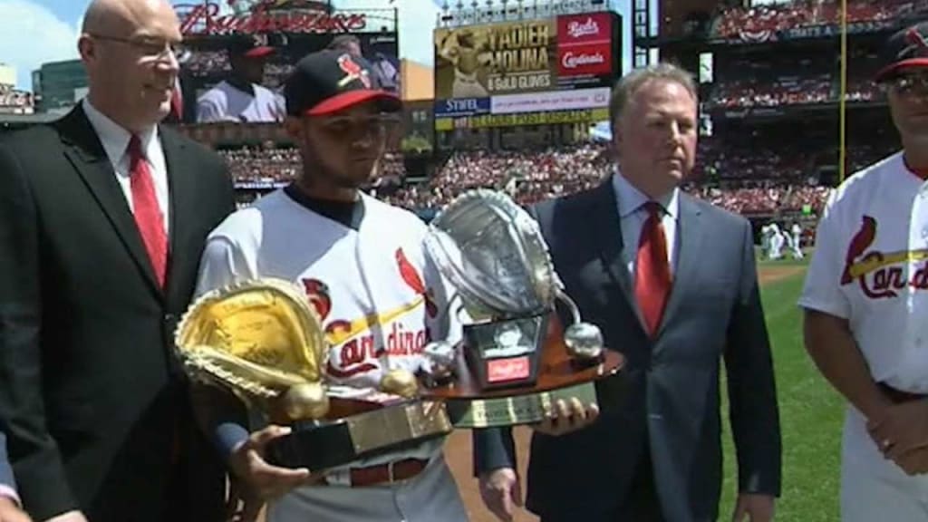 St. Louis Cardinals catcher Yadier Molina leaves the field after receiving  the inaugural Rawlings Platinum Glove Award before a game against the  Milwaukee Brewers at Busch Stadium in St. Louis on April