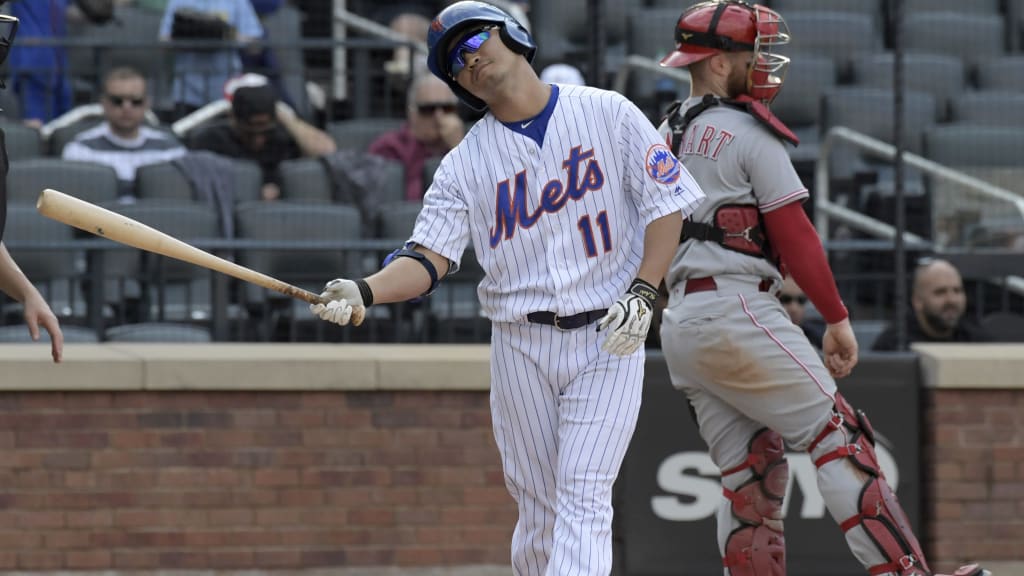 New York Mets' Norichika Aoki (11) reacts after striking out during the ninth inning of a baseball game as Cincinnati Reds catcher Tucker Barnhart, right, looks on Sunday, Sept. 10, 2017, in New York. (AP Photo/Bill Kostroun)