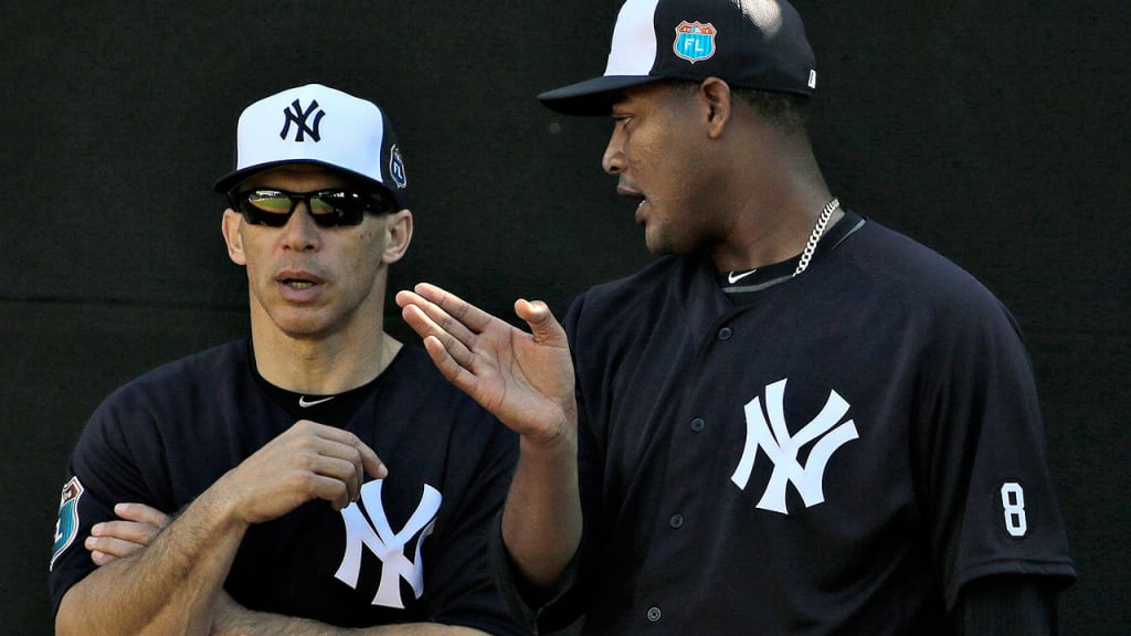 Yankees manager Joe Girardi meets with right-hander Ivan Nova -- a rotation hopeful and candidate for long relief -- during Spring Training. (AP)