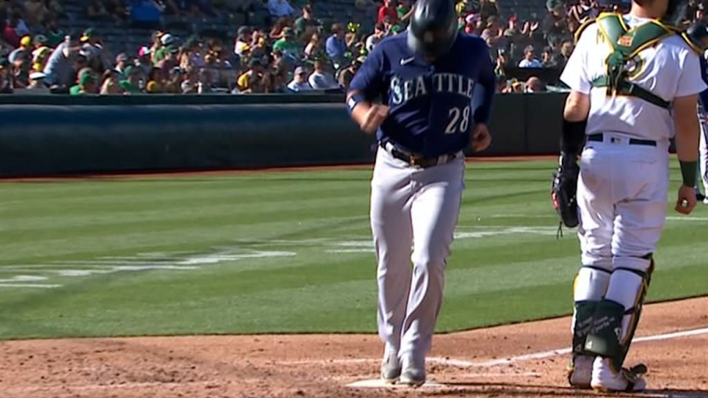 Seattle Mariners' Eugenio Suarez makes a heart shape after hitting