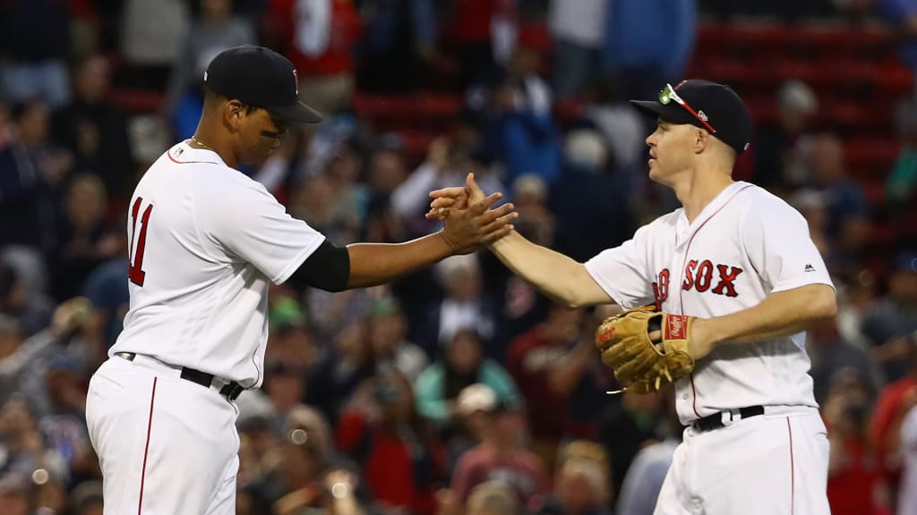 BOSTON, MA - SEPTEMBER 30: Brock Holt (R) #12 of the Boston Red Sox and Rafael Devers #11 of the Boston Red Sox high-five after the game against the New York Yankees at Fenway Park on September 30, 2018 in Boston, Massachusetts. (Photo by Omar Rawlings/Getty Images)