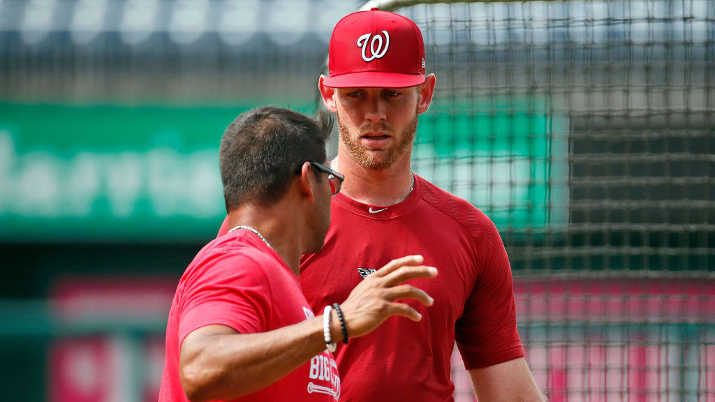 Nationals manager Dave Martinez talks with pitcher Stephen Strasburg during a sim-game workout at Nationals Park on July 6, 2018.