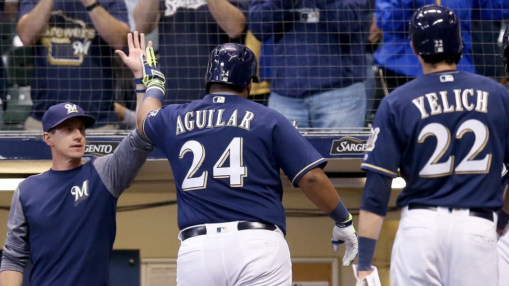 MILWAUKEE, WI - SEPTEMBER 19: Manager Craig Counsell of the Milwaukee Brewers celebrates with Jesus Aguilar #24 after Aguilar hit a home run in the third inning against the Cincinnati Reds at Miller Park on September 19, 2018 in Milwaukee, Wisconsin. (Photo by Dylan Buell/Getty Images)