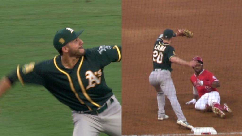 Oakland Athletics' Ramon Laureano, left, is tagged out by Houston