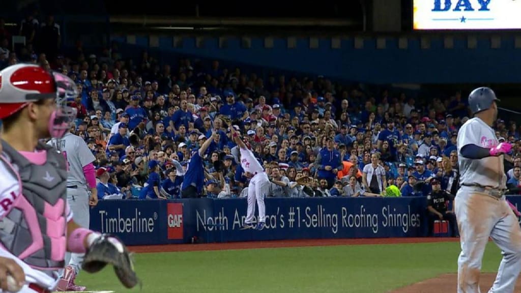 Ball dude leaps for a nice catch