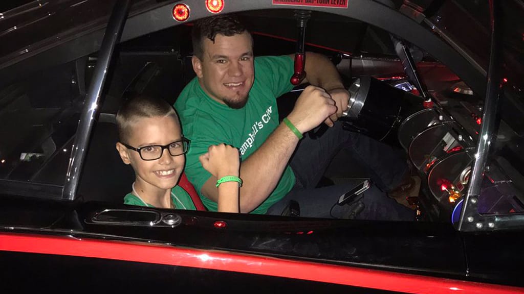 Kyle Schwarber drove around 10-year-old Campbell Faulkner, who is battling a rare mitochondrial disease, in the Batmobile. (Kyle Schwarber on Twitter)
