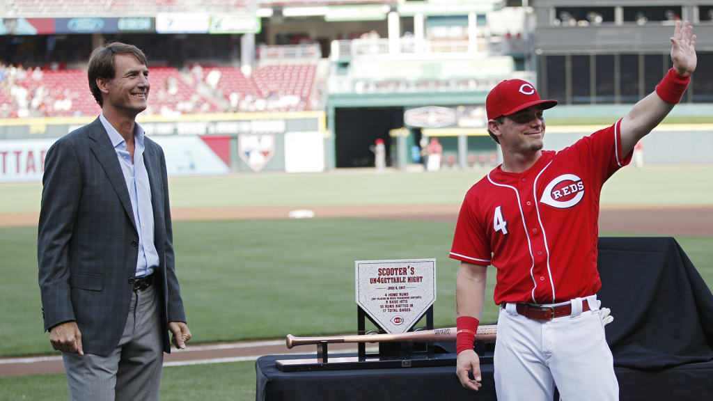 CINCINNATI, OH - JUNE 16: Scooter Gennett #4 of the Cincinnati Reds waves to fans while standing with general manager Dick Williams during a ceremony to commemorate his four home run game from June 6 prior to a game against the Los Angeles Dodgers at Great American Ball Park on June 16, 2017 in Cincinnati, Ohio. (Photo by Joe Robbins/Getty Images)