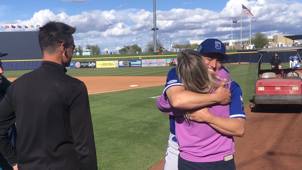 Jonah Dipoto embraces his mother, Tamie, after pitching in his first big league Spring Training game against the Mariners, whose baseball operations are overseen by his father, Jerry, to his right.