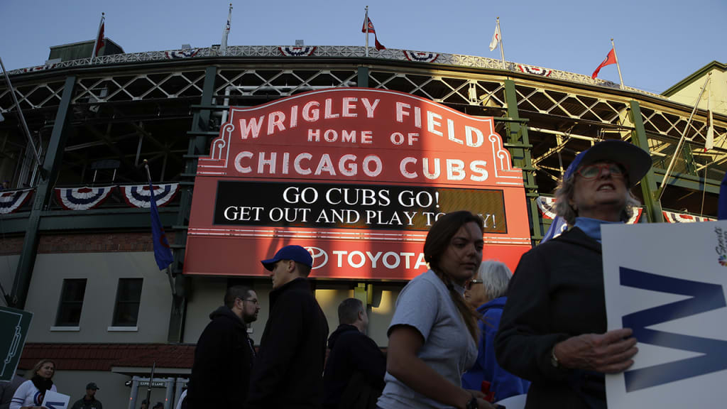 Fans arrive at Wrigley Field before Game 3 of baseball's National League Championship Series between the Chicago Cubs and the Los Angeles Dodgers, Tuesday, Oct. 17, 2017, in Chicago. (AP Photo/Nam Y. Huh)