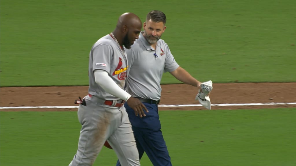 St. Louis Cardinals' Marcell Ozuna, right, leaves the field with an injury  accompanied by a trainer during the third inning of a baseball game against  the San Diego Padres Friday, June 28