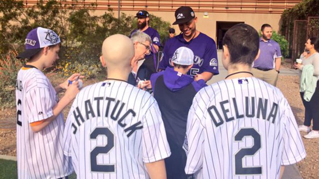 Carlos Gonzalez signs autographs for visitors from Children's Hospital Colorado.