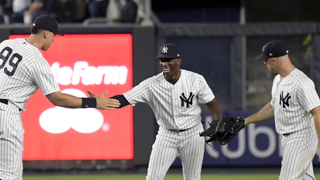 New York Yankees' Aaron Judge (99), Andrew McCutchen and Brett Gardner, right, celebrate after the Yankees defeated the Toronto Blue Jays 11-0 in a baseball game Friday, Sept.14, 2018, at Yankee Stadium in New York. (AP Photo/Bill Kostroun)
