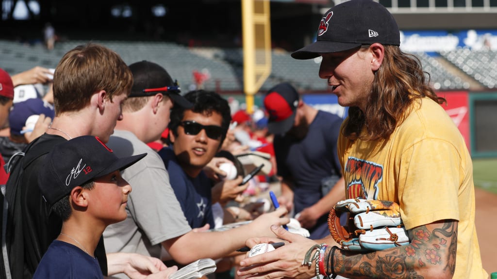 Cleveland Indians' Mike Clevinger, right, greets 12-year-old fan Alex Olguin, left, before a baseball game against the Texas Rangers, Saturday, July 21, 2018, in Arlington, Texas. (AP Photo/Jim Cowsert)
