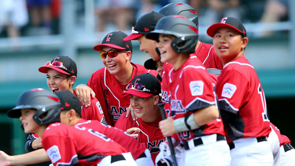 Team Canada waits for Christian Santarelli at home plate after his two-run homer. (Alex Trautwig/MLB Photos)