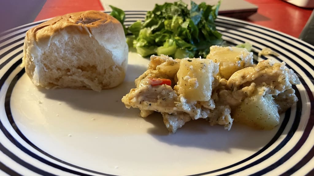 The Hot Chicken Salad, served with a fresh Hawaiian roll and small side salad. Terrible photograph courtesy the author.