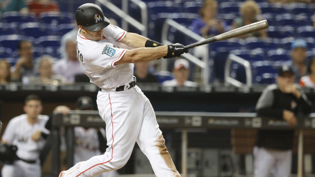 Miami Marlins catcher J.T. Realmuto hits an RBI double in the eighth inning against the Cincinnati Reds during their baseball game in Miami, Thursday, Sept. 20, 2018. The Reds won the game 4-2. (AP Photo/Joe Skipper)