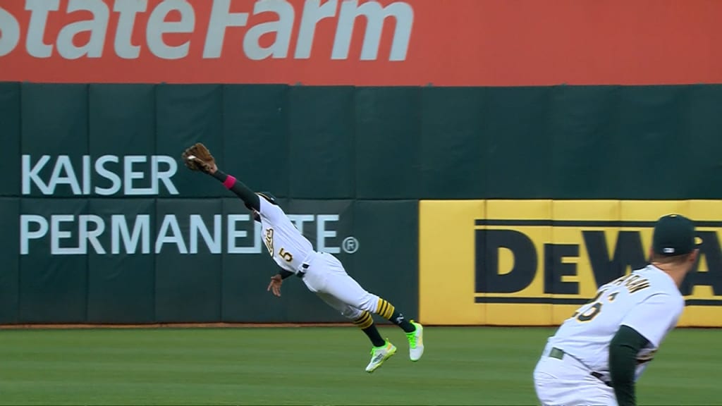 CLEVELAND, OH - JUNE 20: Oakland Athletics second baseman Tony Kemp (5)  makes a diving catch during the eighth inning of the Major League Baseball  game between the Oakland Athletics and Cleveland