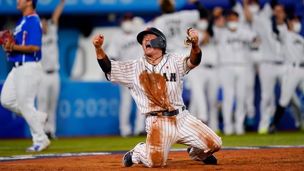 Tayuka Kai reacts after scoring on Tetsuto Yamada's bases-clearing double. (AP/Matt Slocum)