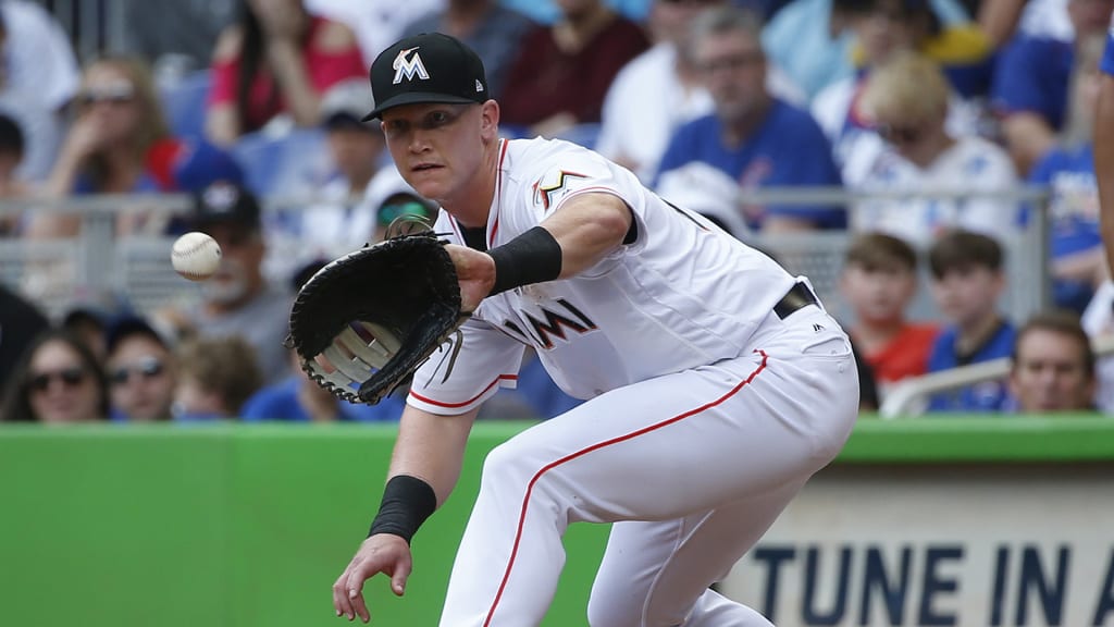 Miami Marlins first baseman Garrett Cooper puts out Chicago Cubs' Victor Caratini during the fourth inning of a baseball game, Sunday, April 1, 2018, in Miami. (AP Photo/Wilfredo Lee)