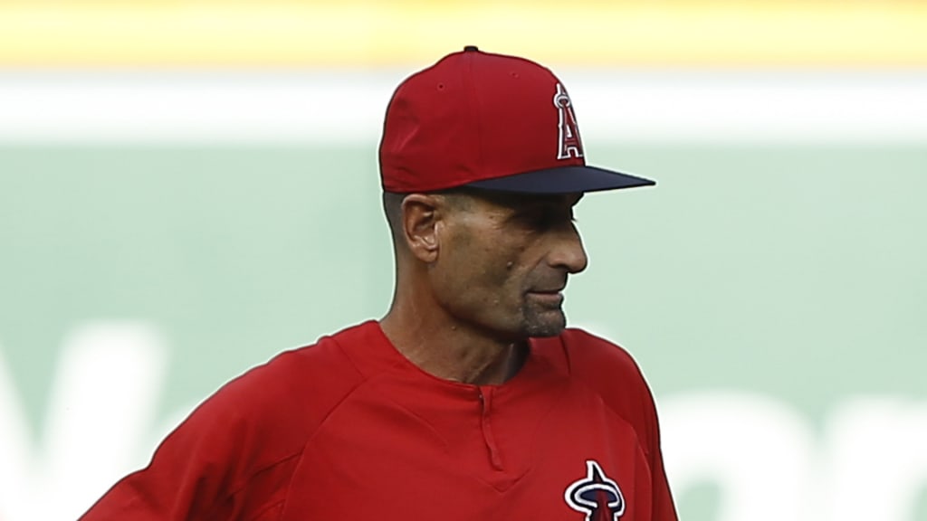 Los Angeles Angels manager Mike Scioscia, right, talks with coach Dino Ebel during batting warmups before a baseball game against the Texas Rangers in Anaheim, Calif., Wednesday, Sept. 26, 2018. (AP Photo/Alex Gallardo)