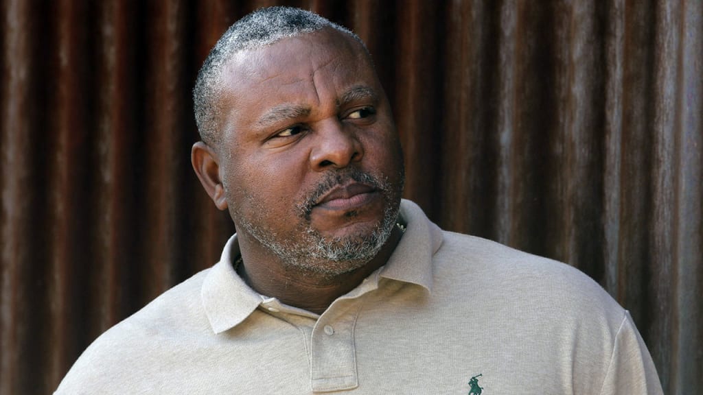 Former baseball player Albert Belle looks on as he visits the Cleveland Indians' spring training camp in Goodyear, Ariz., Tuesday, Feb. 28, 2012. Once one of the game's most feared hitters, Belle made a surprise visit to Cleveland's spring training camp. (AP Photo/Jae C. Hong)