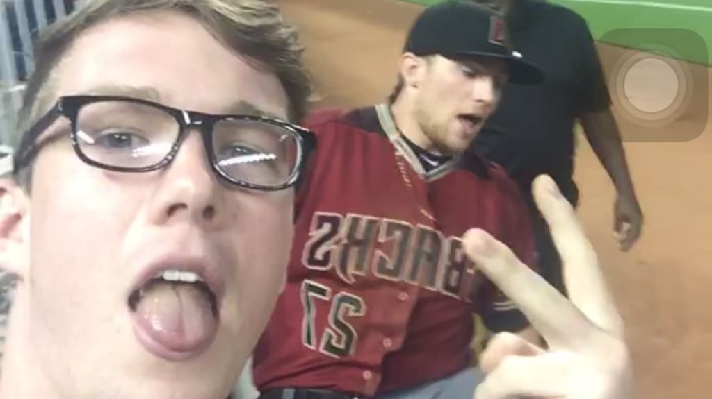 Fan takes selfie after Brandon Drury's tumbling catch