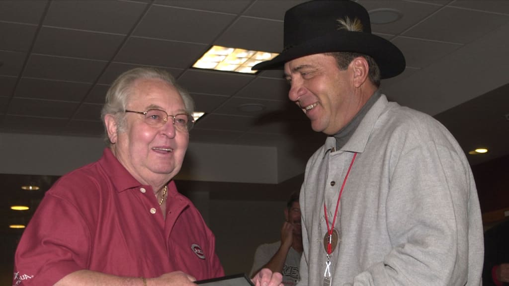 Bernie Stowe (left) was presented a plaque naming the home clubhouse after him by Johnny Bench. He joined the Reds as a batboy in 1947. (AP)