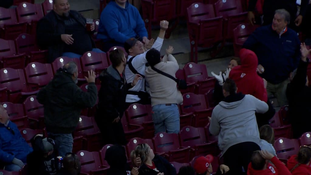 Fan makes incredible catch on foul ball while bottle feeding baby