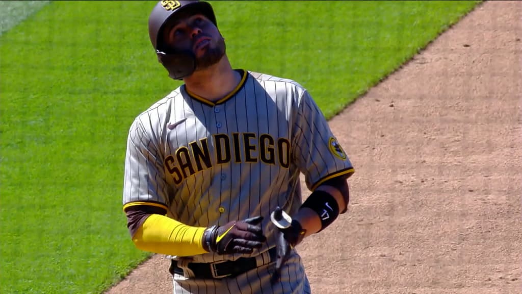 San Diego Padres' Victor Caratini heads up the first-base line after  connecting for a grand slam off Colorado Rockies relief pitcher Robert  Stephenson in the sixth inning of game one of a