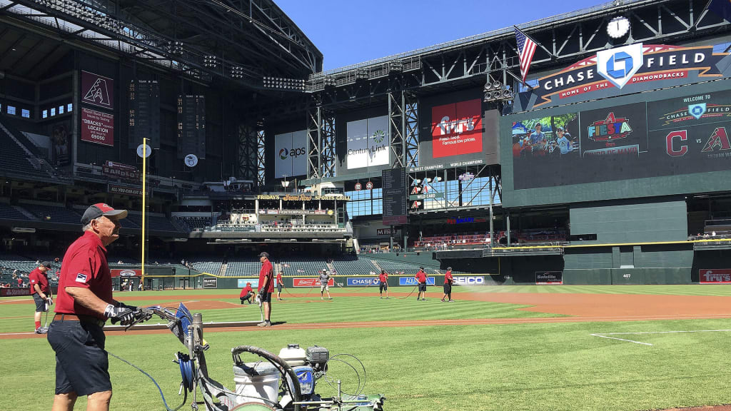 The grounds crew at Chase Field prepares the field prior to a spring training baseball game between the Arizona Diamondbacks and the Cleveland Indians on Tuesday, March 27, 2018, in Phoenix. The game ended in a 3-3 tie. (AP Photo/Ross D. Franklin)