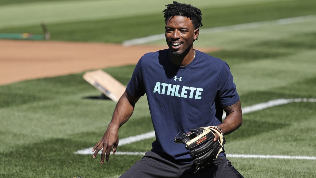 Seattle Mariners center fielder Dee Gordon smiles as he goes through a drill before the team's baseball game against the Texas Rangers Tuesday, May 15, 2018, in Seattle. Gordon could fill in at second base while Robinson Cano is out for 80 games on suspension for violating baseball's joint drug agreement. (AP Photo/Elaine Thompson)
