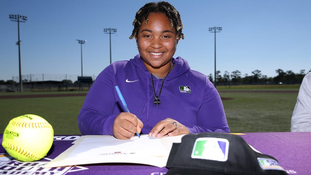 Ca’Terra Bates signs her commitment to Grambling State University during National Signing Day at the New Orleans Youth Academy on Saturday.