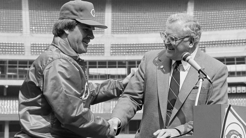 Pete Rose shakes hands with Bob Howsam at the press conference naming Rose player-manager in 1984.