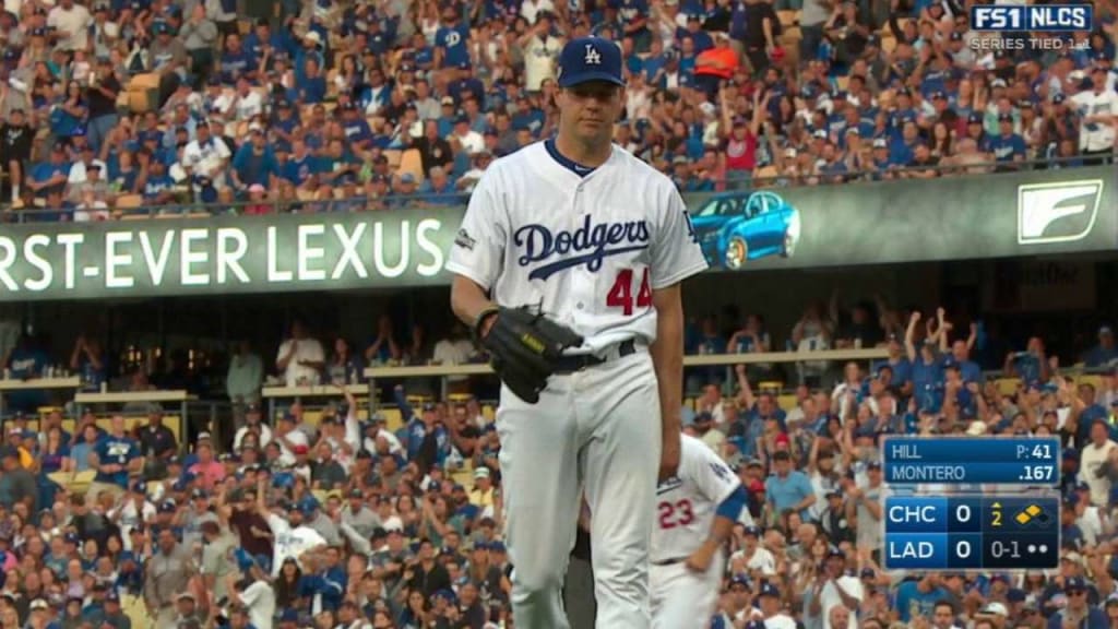 Chicago Cubs starting pitcher John Lackey (41) warms his hands against the  Los Angeles Dodgers during