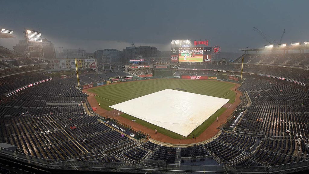 The tarp was on the field early at Nats Park, as the forecast called for showers around first pitch. (AP)