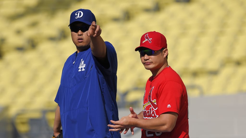 Hyun-Jin Ryu hangs with countryman Seung Hwan Oh on Friday at Dodger Stadium. (AP)