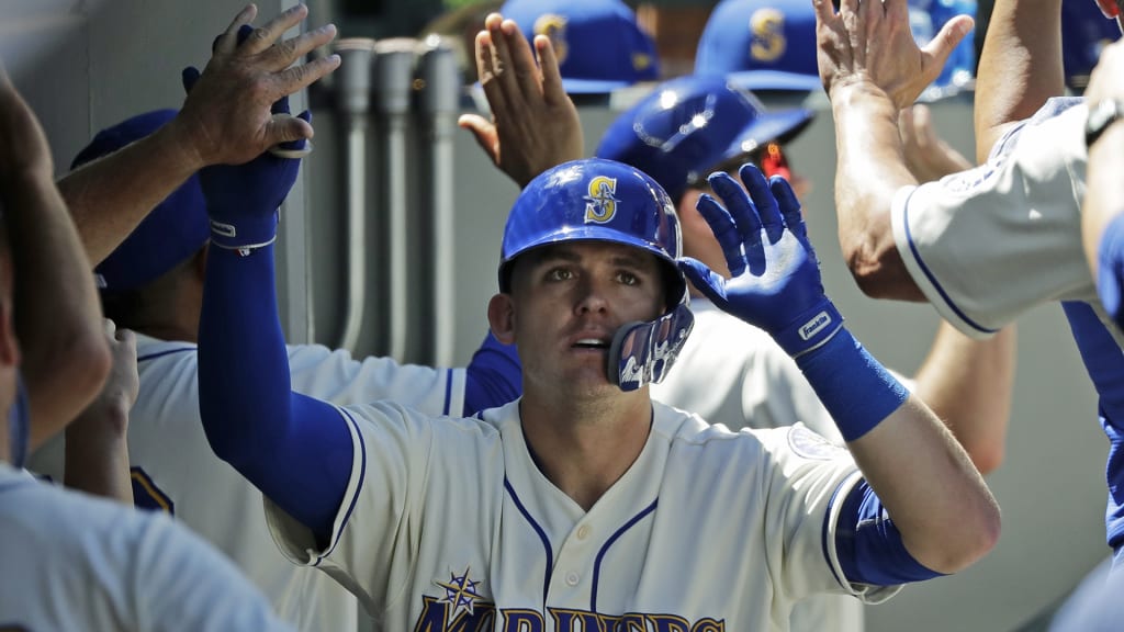 Seattle Mariners' Ryon Healy is greeted in the dugout after he hit a three-run home run against the Colorado Rockies during the sixth inning of a baseball game, Sunday, July 8, 2018, in Seattle. (AP Photo/Ted S. Warren)