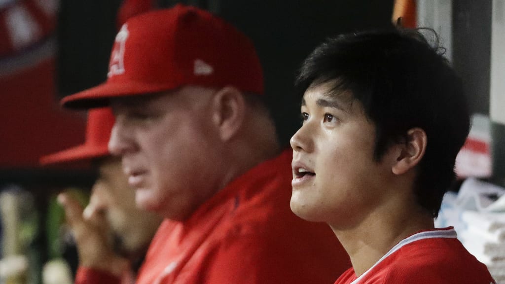 Los Angeles Angels starting pitcher Shohei Ohtani, of Japan, sits with manager Mike Scioscia before a baseball game against the Seattle Mariners in Anaheim, Calif., Thursday, Sept. 13, 2018. (AP Photo/Chris Carlson)