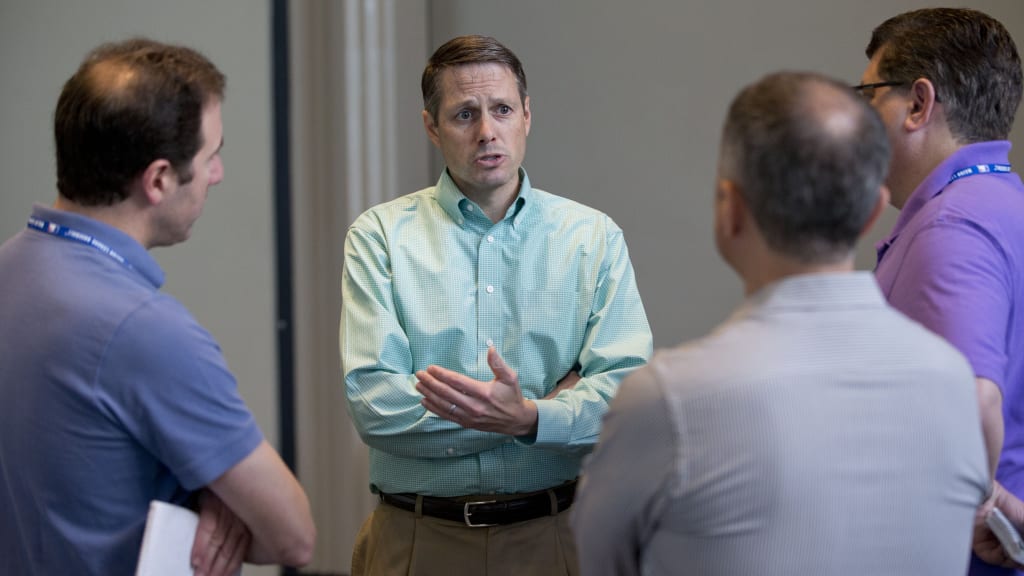 John Ricco, second from left, New York Mets assistant general manager, speaks to reporters after attending the baseball general managers' meetings, Wednesday, Nov. 11, 2015, in Boca Raton, Fla. (AP Photo/Wilfredo Lee)