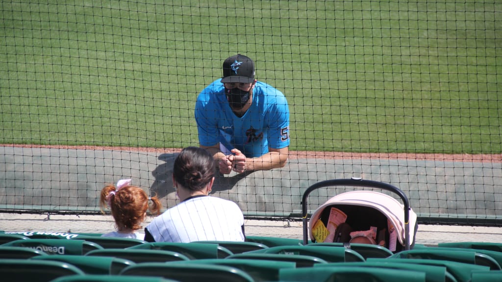 Anthony Bass chats with his family before a Grapefruit League game.