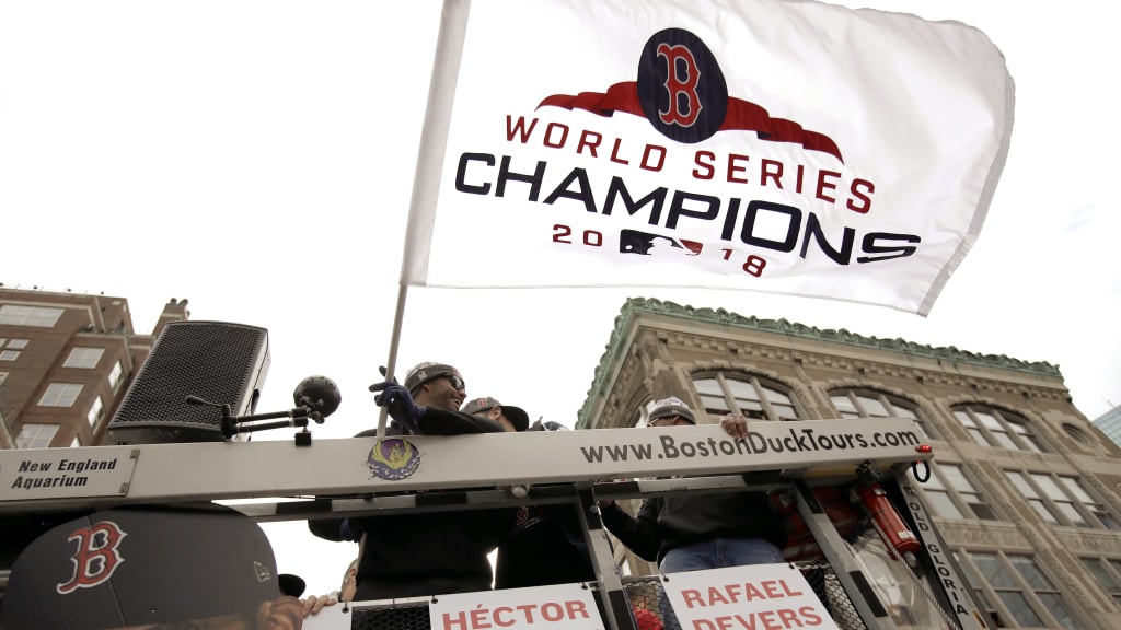 Boston Red Sox's J.D. Martinez waves the championship flag during a parade to celebrate the team's World Series victory over the Los Angeles Dodgers, Wednesday, Oct. 31, 2018, in Boston. (AP Photo/Charles Krupa)