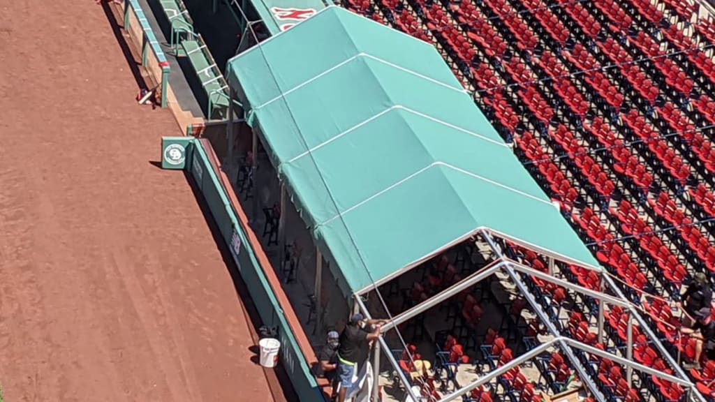 Boston Red Sox install green tents for extra Fenway Park dugout