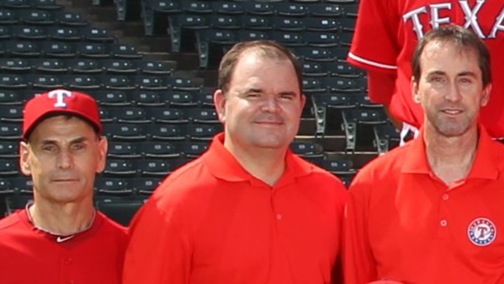 Traveling secretary Chris Lyngos (center) passed away suddenly on Nov. 22. (Texas Rangers)