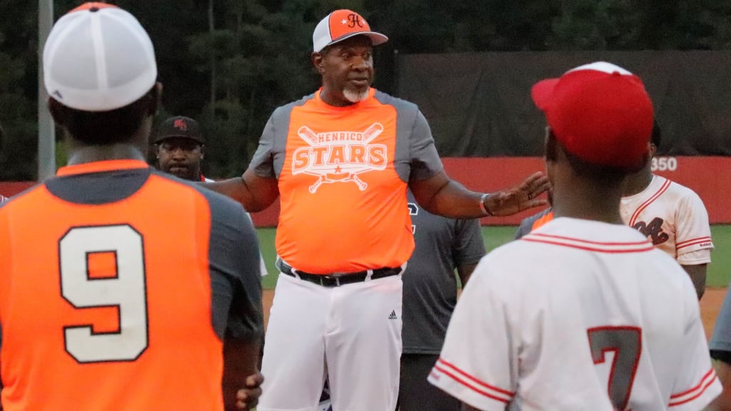 Bishop Husband talks with the players.