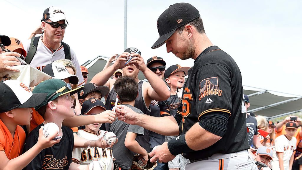 Buster Posey signs autographs prior to returning to the Giants' lineup Friday against the A's. (Getty)
