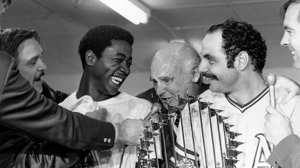 Allan Lewis (left) celebrates winning the 1972 World Series with A's owner Charlie Finley and Sal Bando.