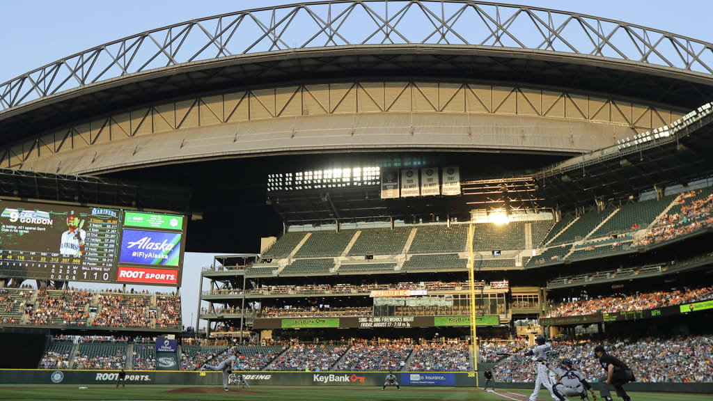 The evening sun glints off a window at Safeco Field as Seattle Mariners leadoff hitter Dee Gordon lines out against Houston Astros starting pitcher Gerrit Cole during the first inning of a baseball game, Monday, July 30, 2018, in Seattle. (AP Photo/Ted S. Warren)